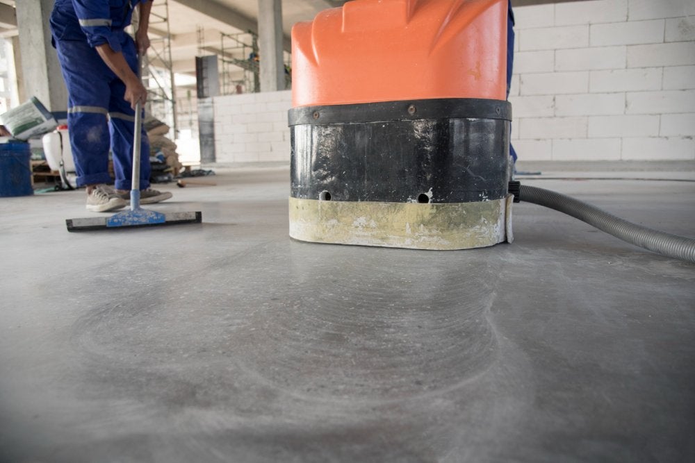 Professional concrete buffing machine in action on a residential floor