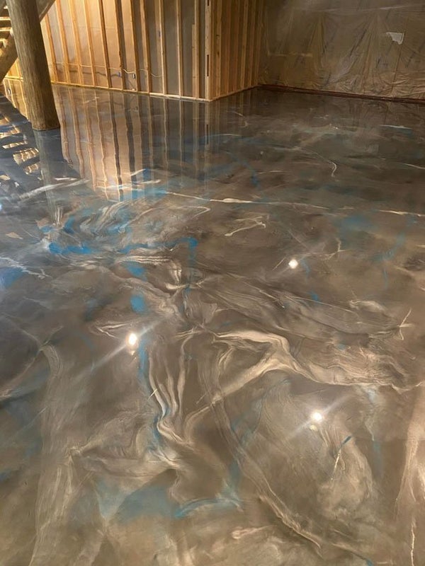 Polyaspartic floor coating with a marbled blue and grey glossy finish